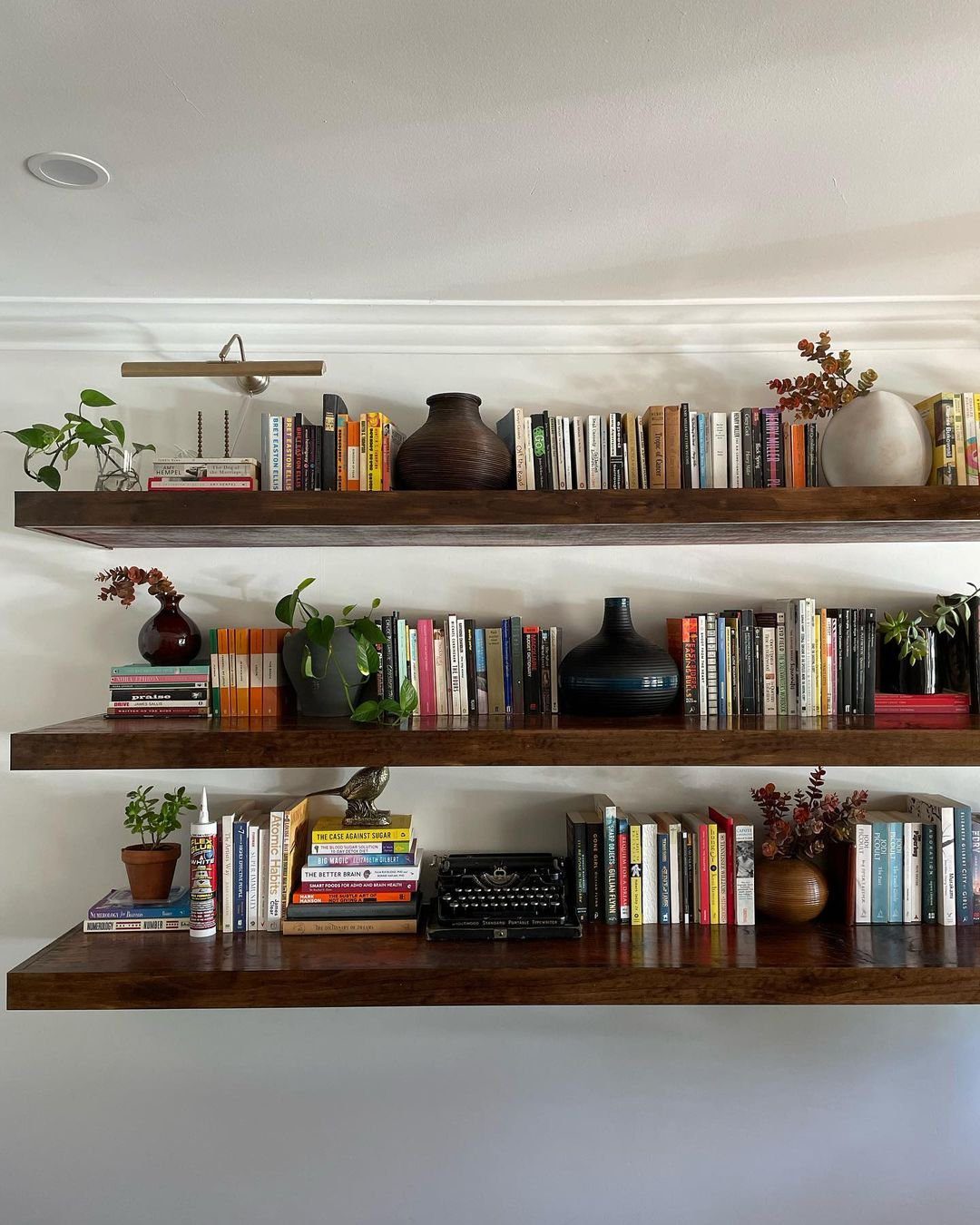 25 Stunning Floating Shelves That Wow in 2025 18 Cultured Comfort with Book-Laden Shelves